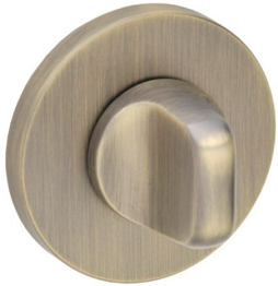 Metalowy zamek w kolorze mosiądzu, okrągła płytka z wystającym pokrętłem.