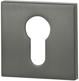 Metalowa osłona zamka w kolorze szarym, z otworem w kształcie klucza pośrodku.