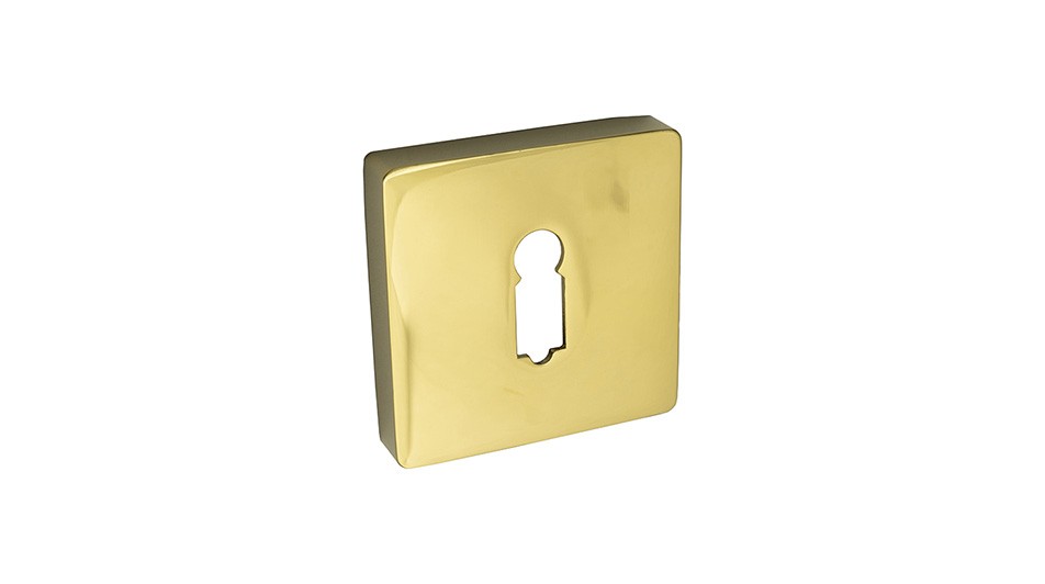 Złota osłona zamka w kształcie kwadratu z wycięciem na klucz.