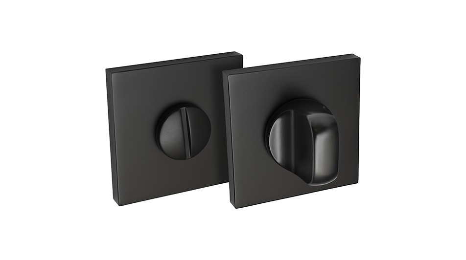 Czarne, kwadratowe elementy zamka, jeden z pokrętłem, drugi z otworem na klucz.