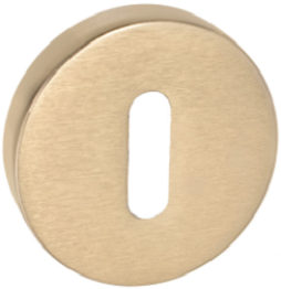 Okrągły, złoty element z otworem w kształcie prostokąta, prawdopodobnie część zamka lub mechanizmu.